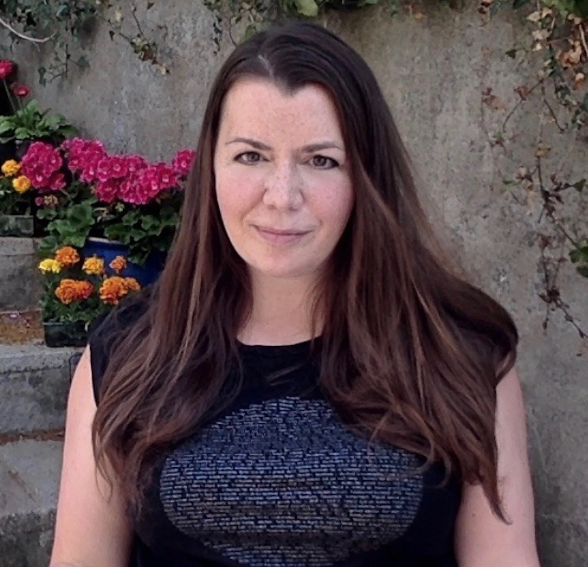 Nadia Edwards, a Holistic Sleep Coach, smiling.