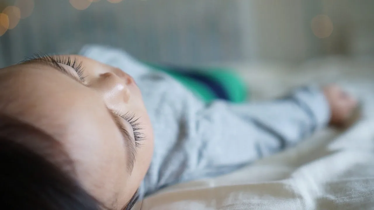 A baby sleeping peacefully in a crib.
